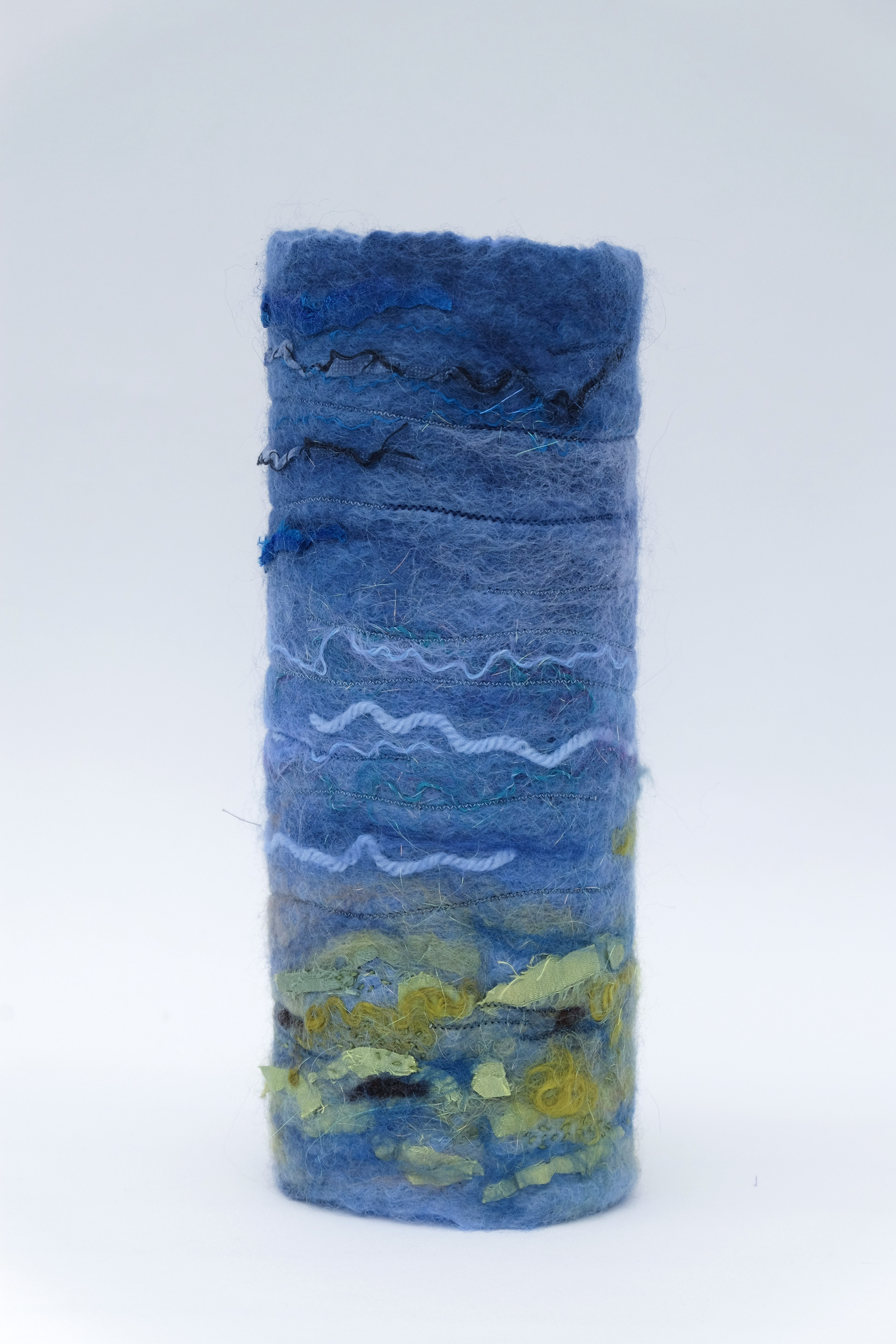 Blue felted vessel with wave patterns